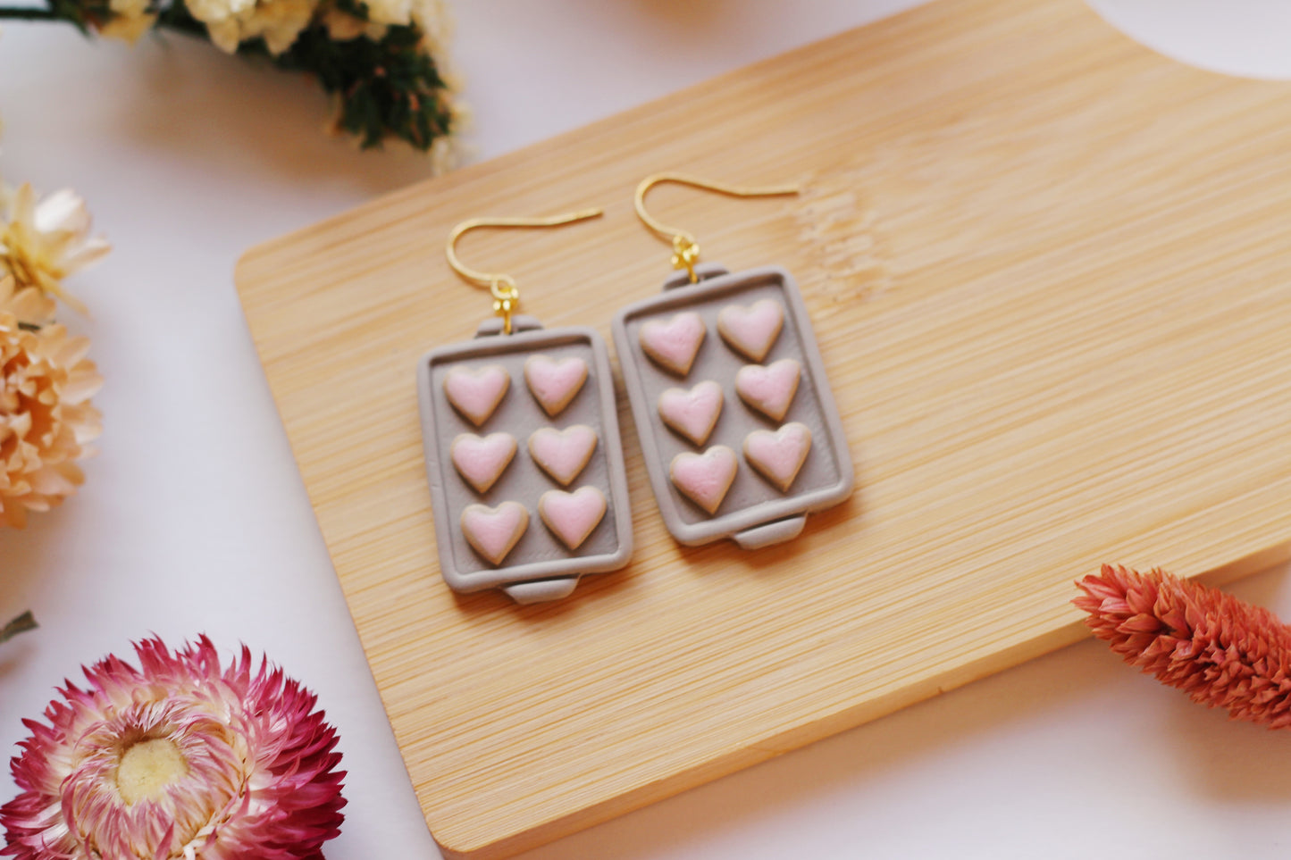 Heart shaped cookies on a baking tray earrings