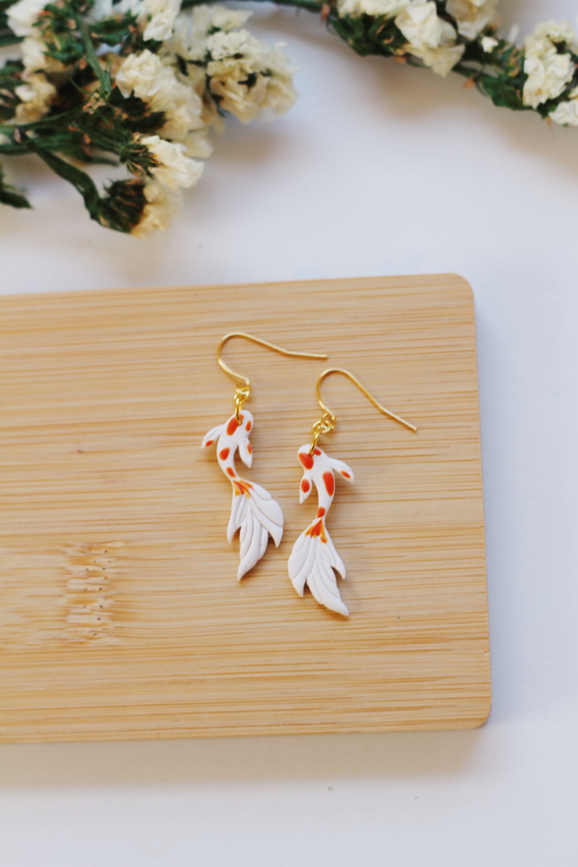 White and orange koi fish earrings with gold hooks