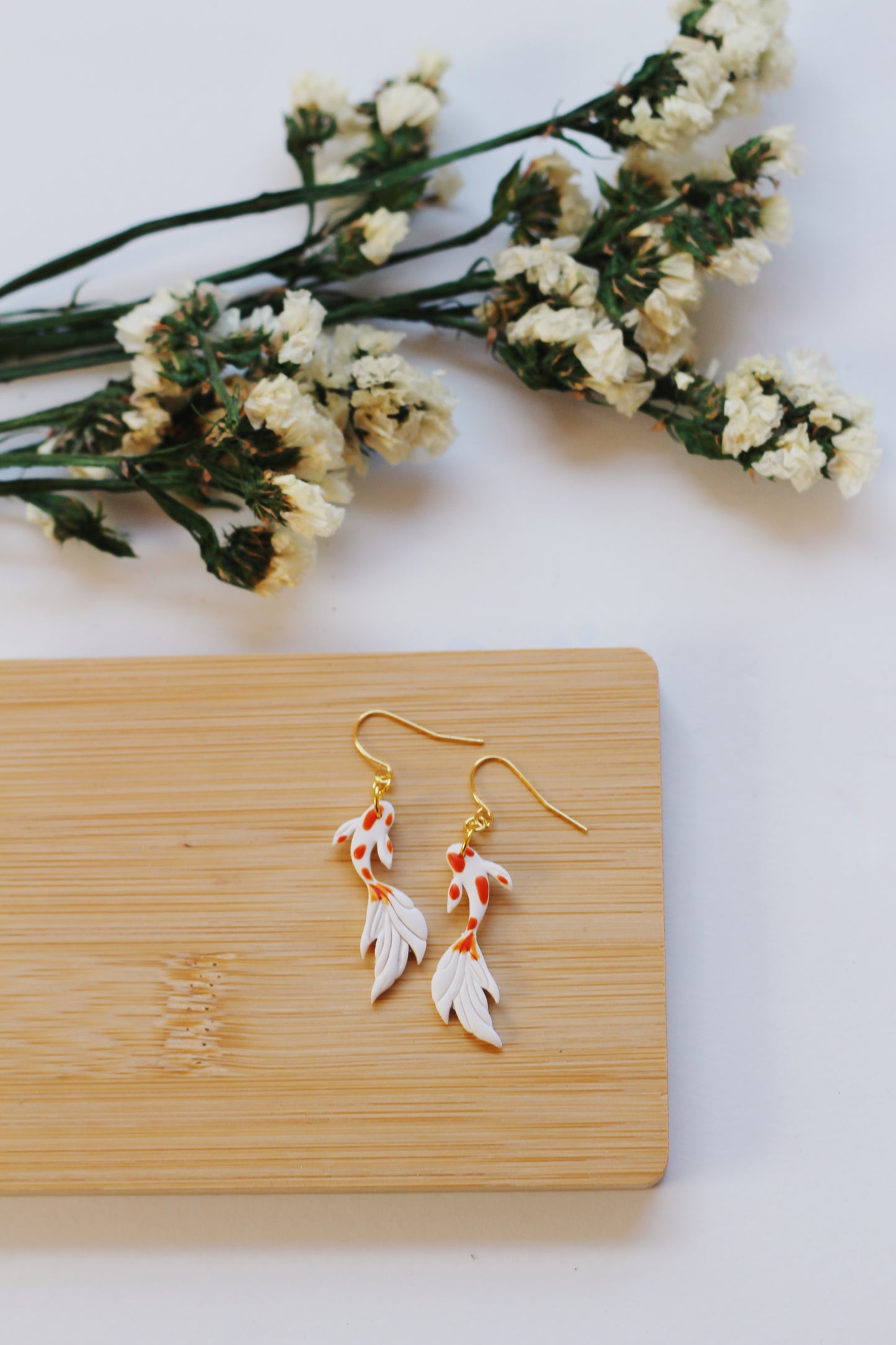 White and orange koi fish earrings with gold hooks