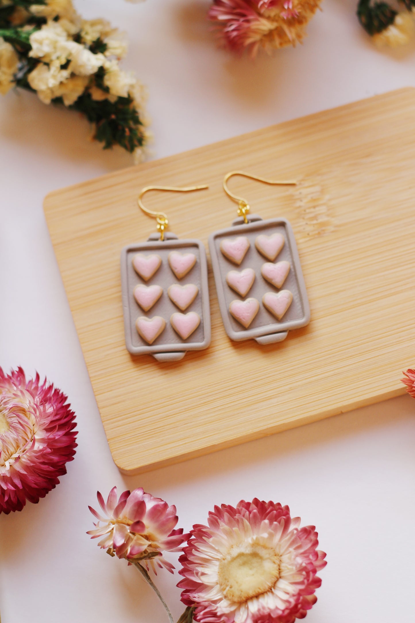 Heart shaped cookies on a baking tray earrings