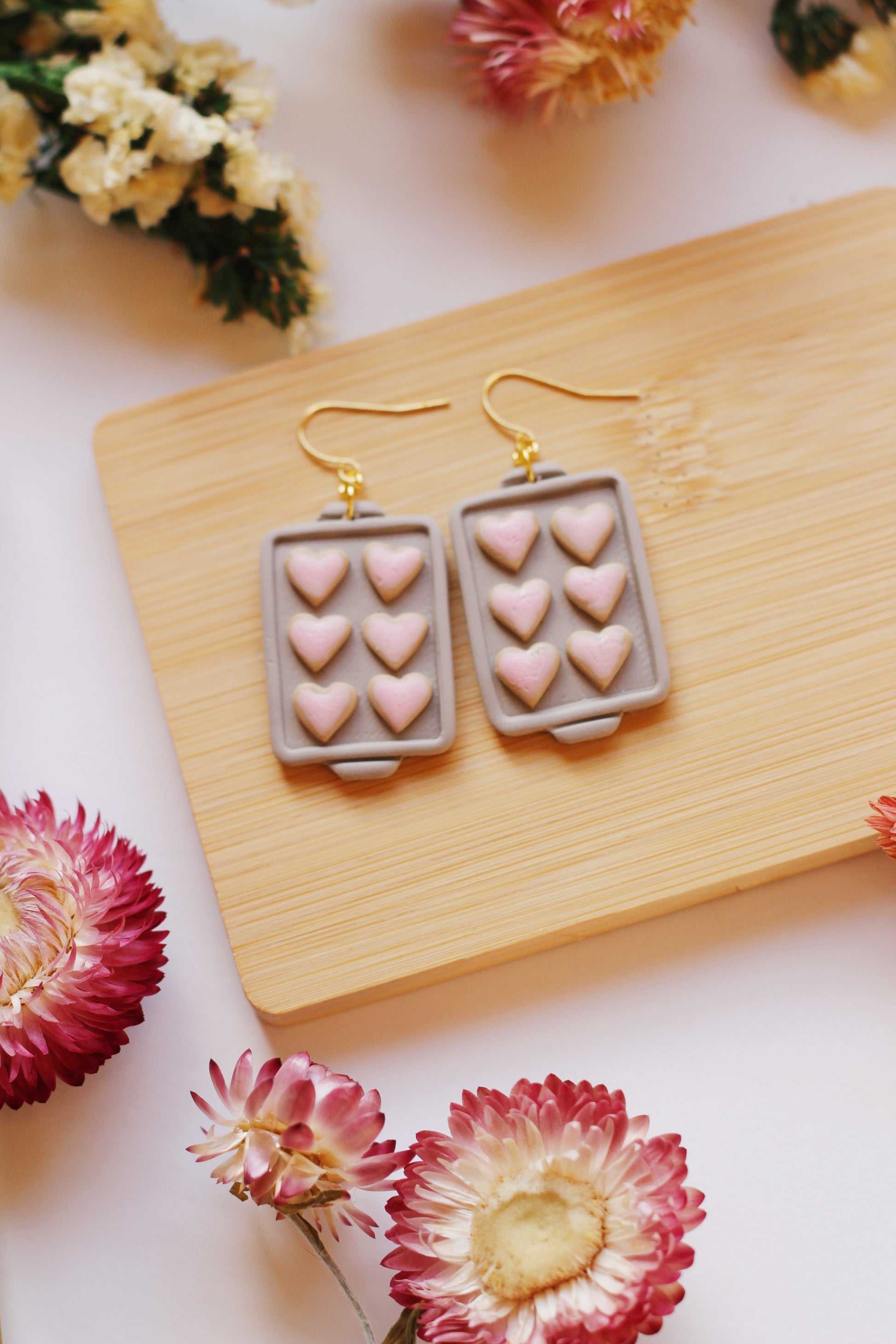 Heart shaped cookies on a baking tray earrings