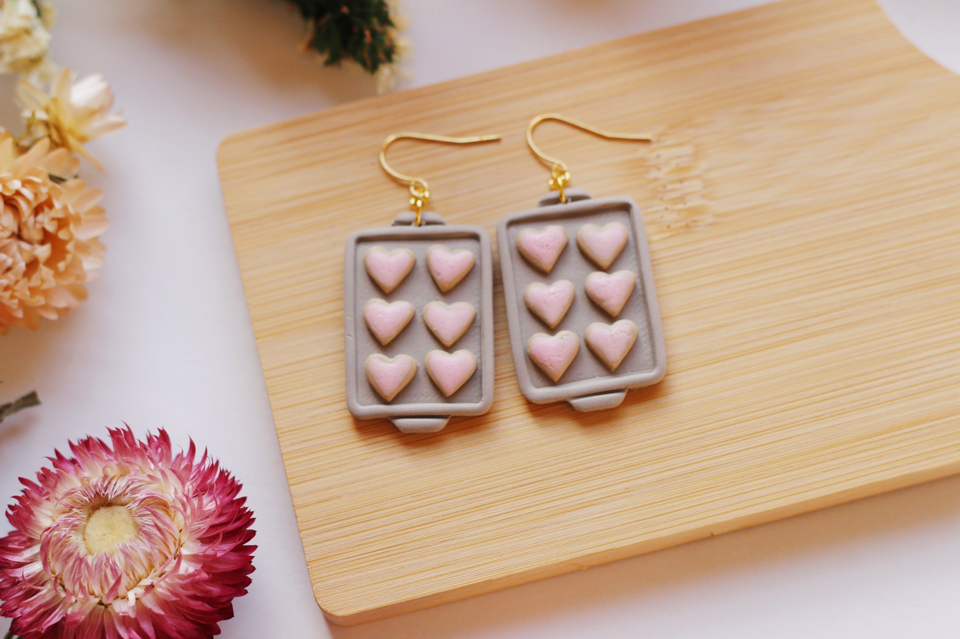 Heart shaped cookies on a baking tray earrings