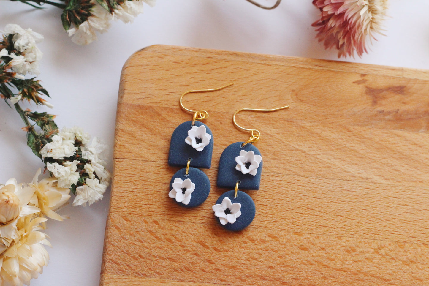Blue clay earrings with white flowers and gold hardware