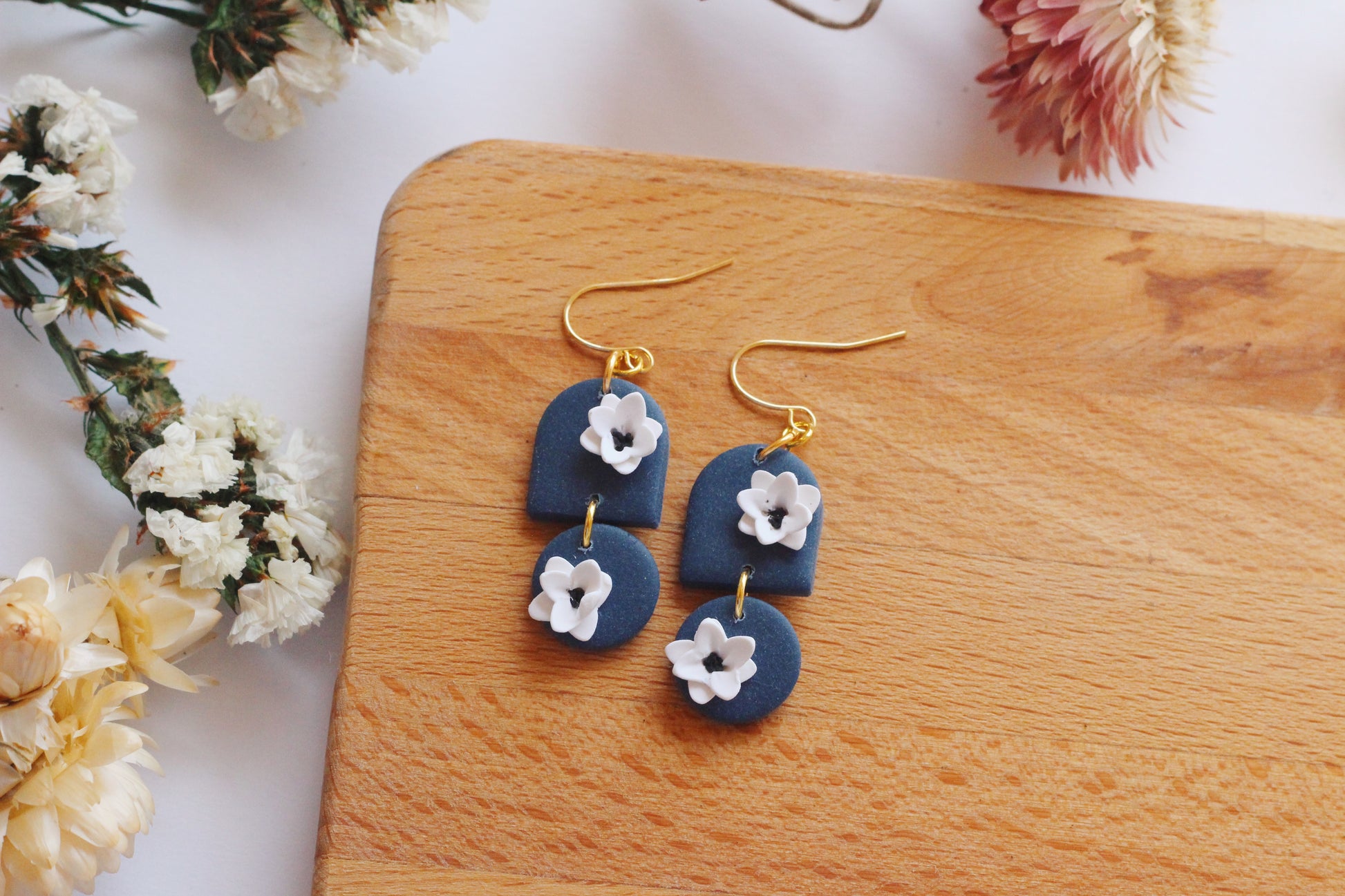 Blue clay earrings with white flowers and gold hardware