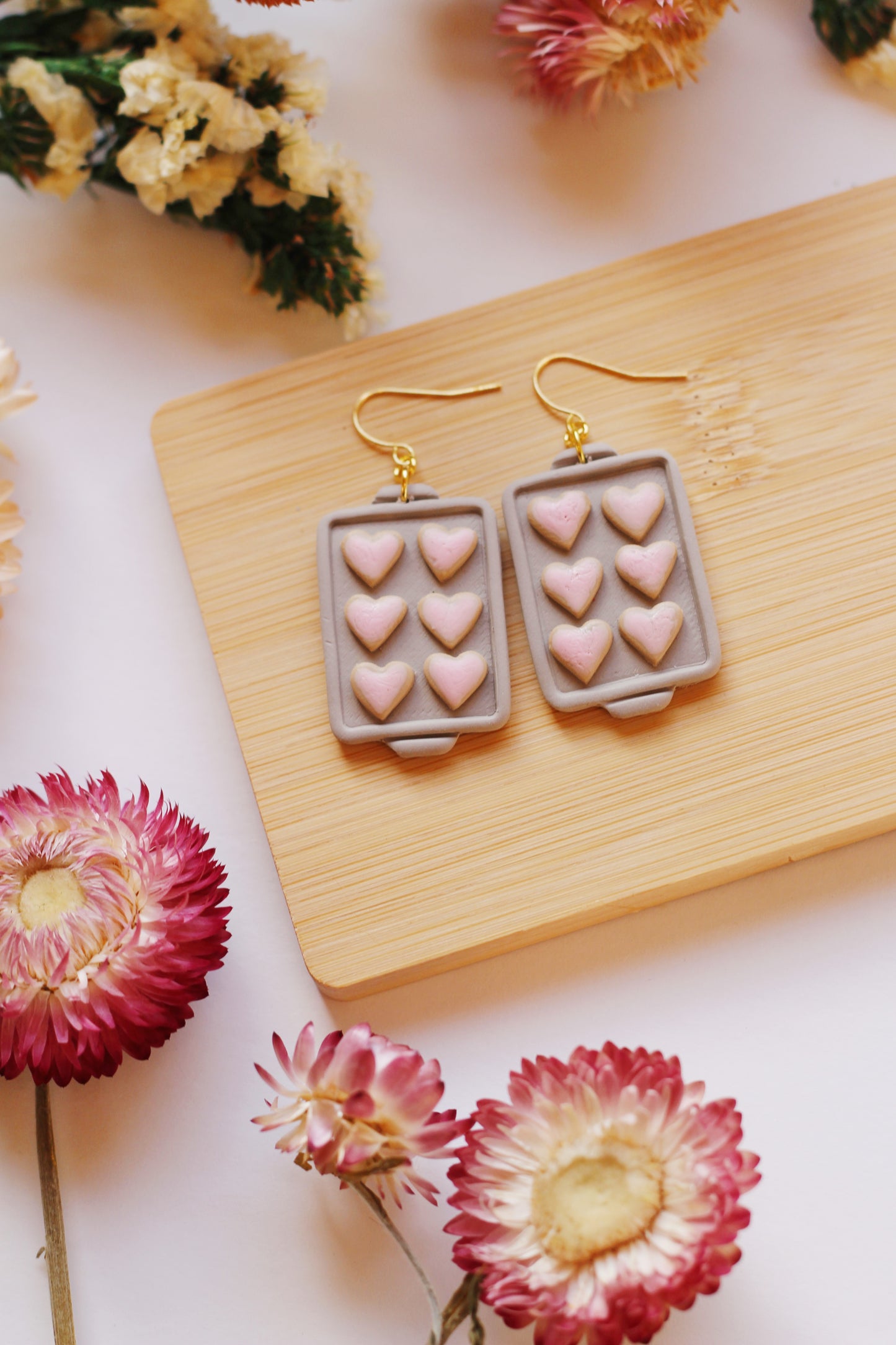 Heart shaped cookies on a baking tray earrings