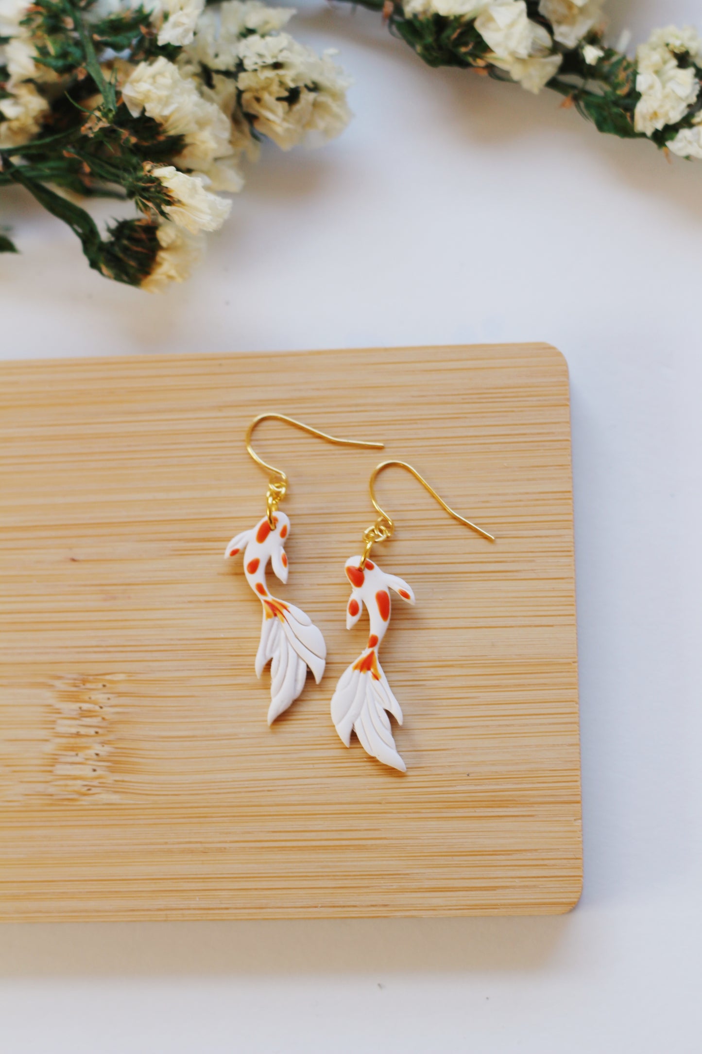 White and orange koi fish earrings with gold hooks